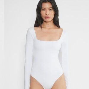 White Aritizia Long Sleeve Bodysuit